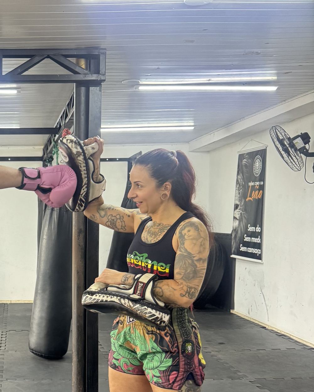 Professora Paola Guimarães segurando a manopla durante o treino
